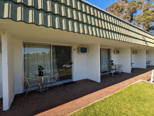 a patio with chairs and a table on a house at Gloucester Motel Pemberton Manjimup in Pemberton