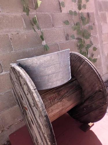 a wooden bench sitting next to a brick wall at Qué Chula casa. in Izamal