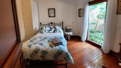 a bedroom with a bed and a large window at Villa Castello in Bodrum City