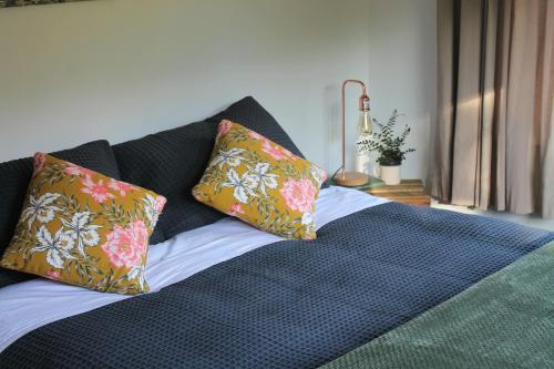 a bed with two pillows on top of it at Bauchops Hill Station Farmstay in Burkes Pass