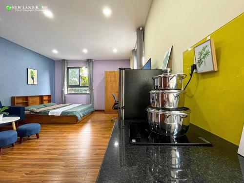 a room with a kitchen with a stove and a bed at NEW LAND Apartment - Phu My Hung in Ho Chi Minh City
