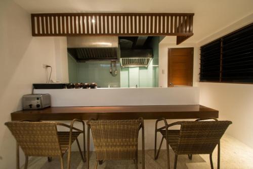 una cucina con tavolo e sedie in una stanza di Signature Boracay formerly La Banca House a Boracay