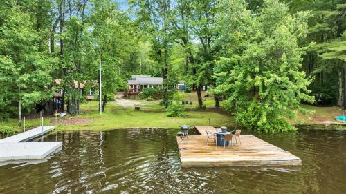a wooden dock in the middle of a lake at CRYSTAL OASIS- LIMIT 8 villa in North Sebago