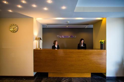 two women sitting at a reception desk in a hotel room at The Athens Gate Hotel in Athens