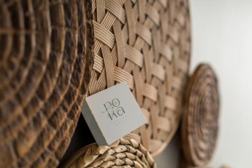 a sign on a wicker vase with a sign on it at Nόka Suite Apartments in Faliraki