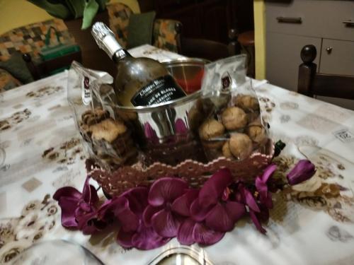 a table with a basket of food and a bottle of wine at Casa Anna in Crosa