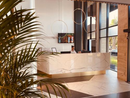 a woman sitting at a desk in a lobby at STEAUA DE MARE - Olimp Resort in Olimp