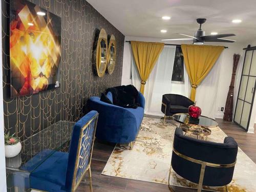 a living room with blue chairs and a table at Atlanta Penthouse King/ Queen Bd in Atlanta