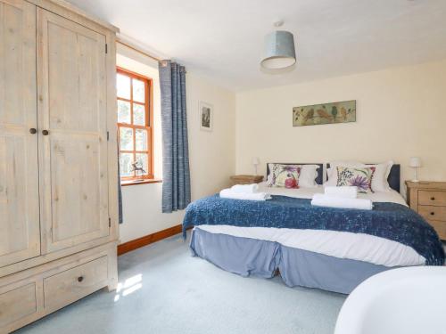 a bedroom with a large bed and a window at Beggars Roost in Truro