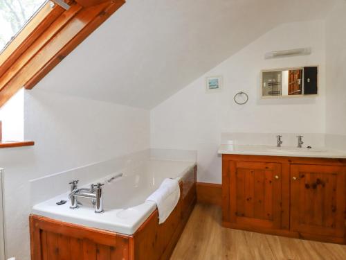 a bathroom with a bath tub and a sink at Beggars Roost in Truro