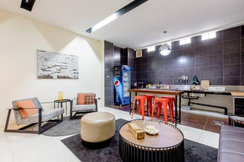 a living room with a table and some chairs at CB's - Cheap Boutique Bangkok in Bangkok