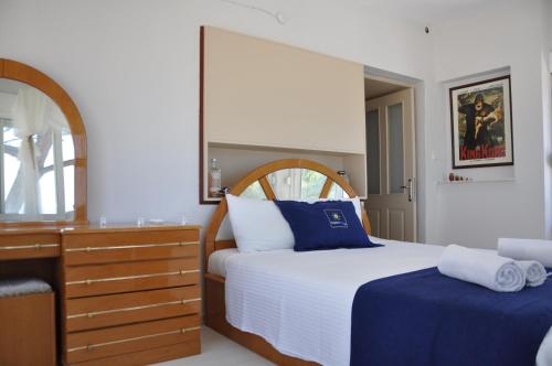 a bedroom with a bed and a dresser at Villa Plaj in Kuşadası