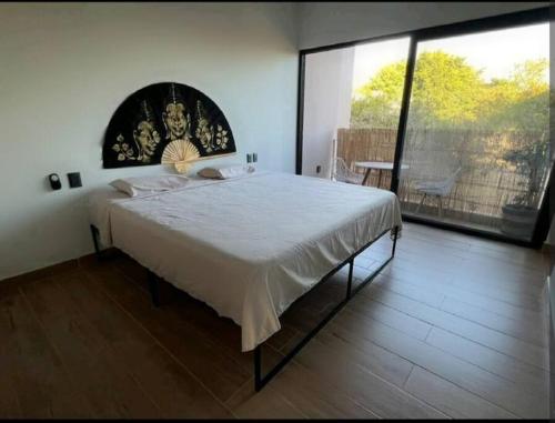 เตียงในห้องที่ Casa Dakini en la Punta with pool and ocean view