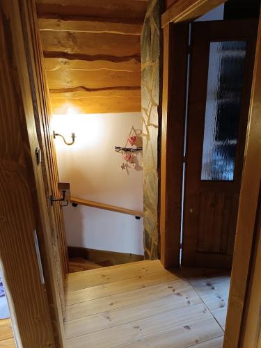 an open door to a room with a hallway at Dolná chata u Bratríkov in Haligovce