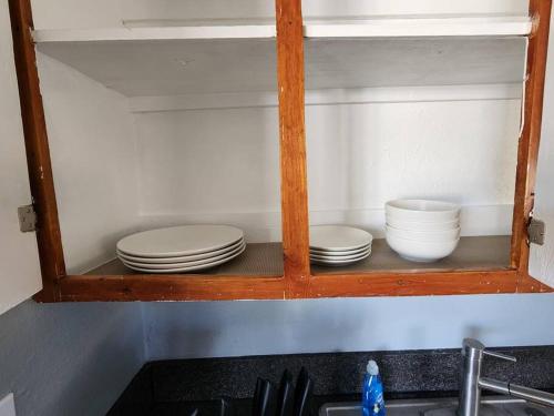 a cabinet with plates and bowls on top of a sink at Comfortable in a 2 bed 2 bath in Lakeland