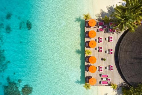 an aerial view of a beach with umbrellas and chairs at Sun Siyam Vilu Reef - 24 Hours All-Inclusive with Free Transfer in Dhaalu Atoll