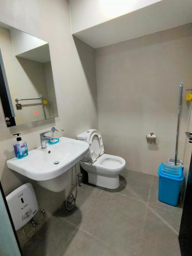 a bathroom with a white sink and a toilet at Aeon Towers studio unit in Davao City