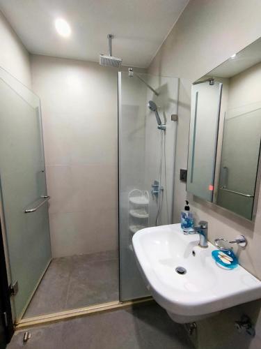 a bathroom with a shower and a sink at Aeon Towers studio unit in Davao City