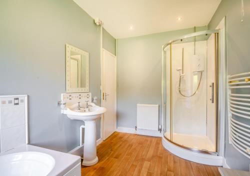 a bathroom with a sink and a shower at Penmaen Bach in Pwllheli