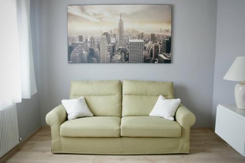 a couch in a living room with a picture on the wall at B&B The Secret Garden in Buia