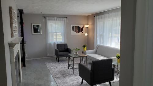 a living room with a couch and chairs and a table at The Mall of America(MOA) House in Bloomington