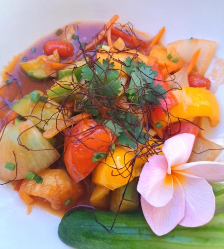 a plate of food with vegetables and a flower on it at Sense Asia in Haad Tian