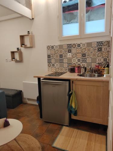 a kitchen with a sink and a counter top at Studette avec le charme de l'ancien in Avignon