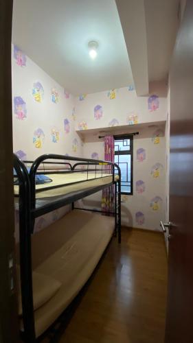 a small room with a bunk bed in it at Apartemen Panoramic by Dio Property in Bandung