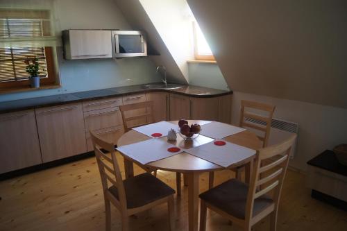 a kitchen with a table and two chairs and a table and a kitchen at Apartament Mountain View in Kościelisko