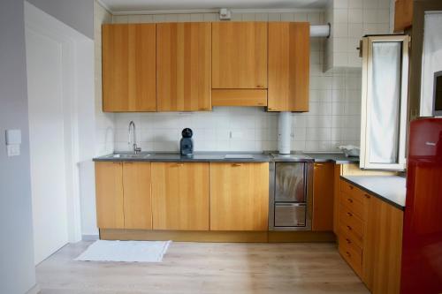 a kitchen with wooden cabinets and a sink at B&B The Secret Garden in Buia