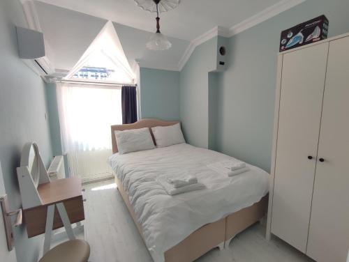 a small bedroom with a bed and a window at Penthouse in Trabzon