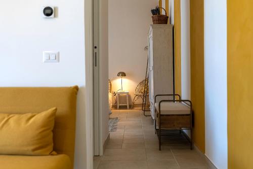 a hallway with a couch and a lamp in a room at Al Piglio Maison de Charme Wine & Wellness Resort in Piglio