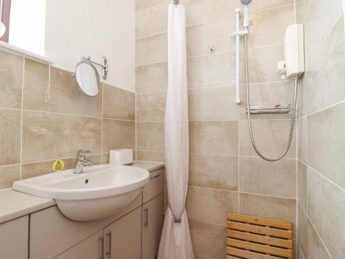 a bathroom with a sink and a shower at Keepers Lodge in Carnforth