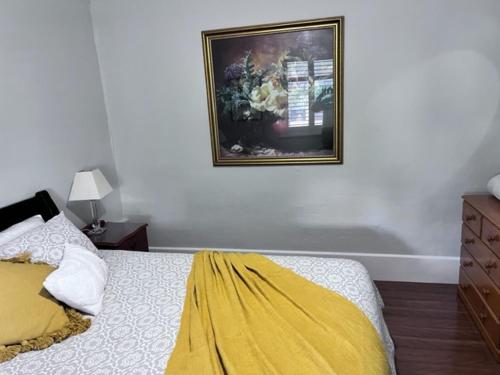 a bedroom with a bed and a picture on the wall at Penzance Cottage in Adelaide