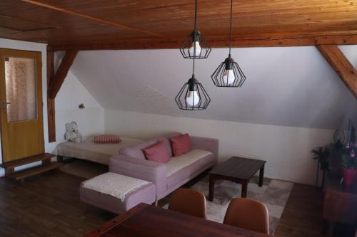 a living room with a couch and two lights at ABC apartments in Černá v Pošumaví