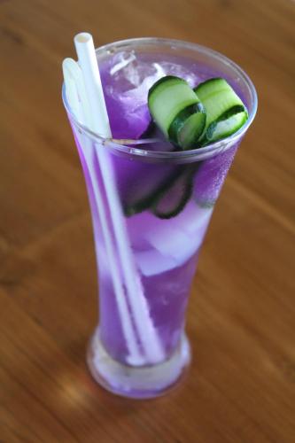 a glass with a purple drink with cucumbers in it at Puri Tempo Doeloe Boutique Hotel in Sanur