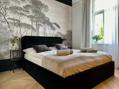 a bedroom with a large bed with a large window at Supreme Apartment in Krakow