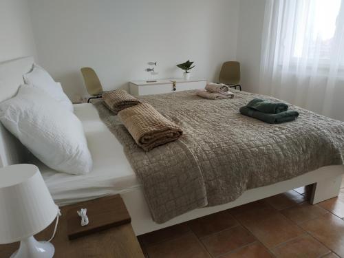 a bed with blankets and pillows on top of it at BBFamily in Balatonboglár