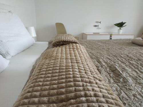 a bed with a brown blanket on top of it at BBFamily in Balatonboglár