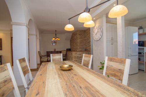 a dining room with a wooden table and chairs at Nereo in Mali Lošinj