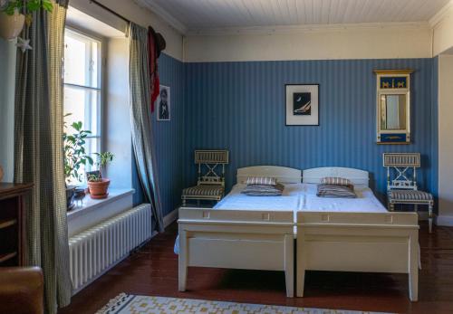 a bedroom with a bed with blue walls at Villa Kingfisher in Åminnefors