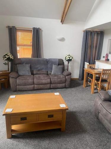 a living room with a couch and a coffee table at Hermon chapel. in Wrexham