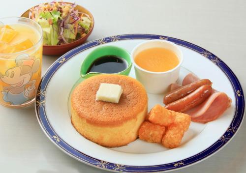 a plate of food with a doughnut and sausage and a salad at Katsuura Hilltop Hotel & Residence in Katsuura
