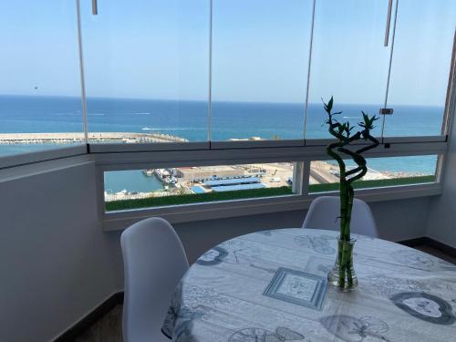 a table with a vase on it with a view of the ocean at Mediterranean View Suite Costa del Sol in Fuengirola