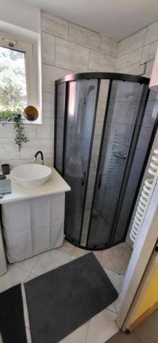 a bathroom with a shower and a sink at Szpitalna 9c in Suwałki