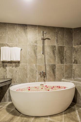 a bathroom with a large white bath tub at Otres Beach Hotel in Sihanoukville