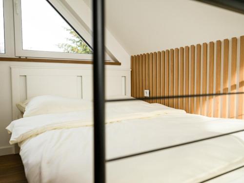 a bedroom with two beds and a window at Warmiński Sad in Olsztyn