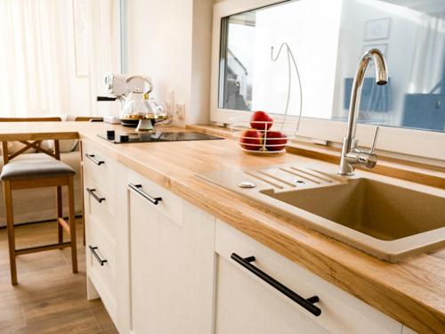 a kitchen with a sink and a counter top at Warmiński Sad in Olsztyn