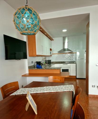 a kitchen with a wooden table and a dining room at BRISA DE CALELLA DE PALAFRUGELL in Calella de Palafrugell