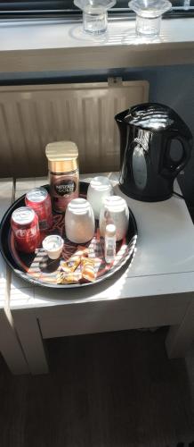 a tray of food on a table with a coffee pot at Den Hvide Farm in Skanderborg